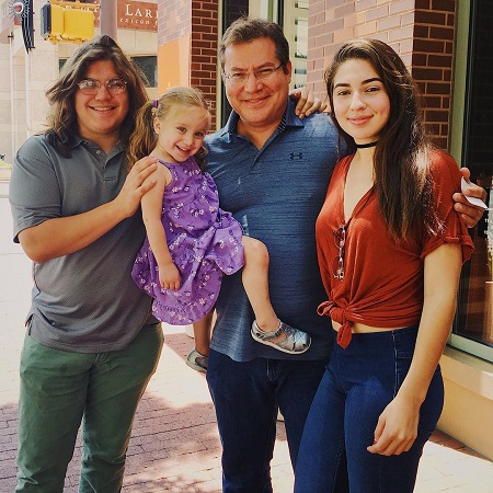 Julio posing with his wife and daiughters